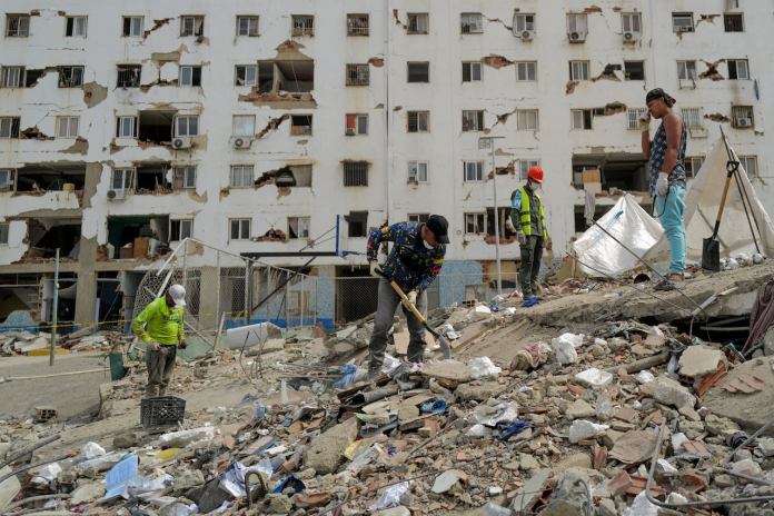 Un rescatista cava entre los escombros mientras busca víctimas en Caraballeda, estado de La Guaira, el 28 de junio de 2026. Foto: Mauricio Valenzuela/AFP